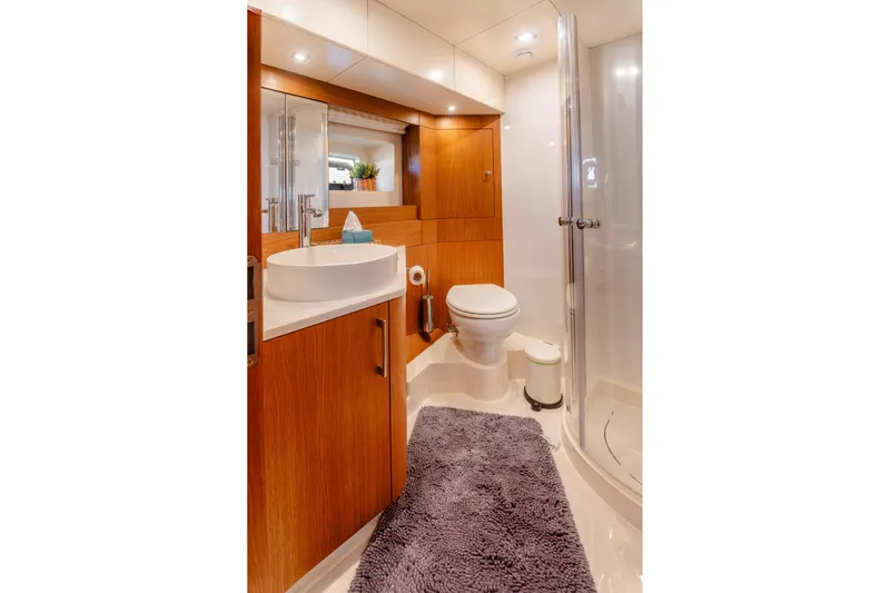 Viakarey Yacht Photos Pics Luxurious bathroom in 2023 Sirena 58 yacht with modern fixtures and wooden cabinetry.