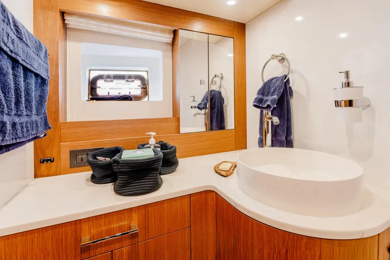 Viakarey Yacht Photos Pics Luxurious bathroom interior of 2023 Sirena 58 yacht with modern fixtures and wooden accents.