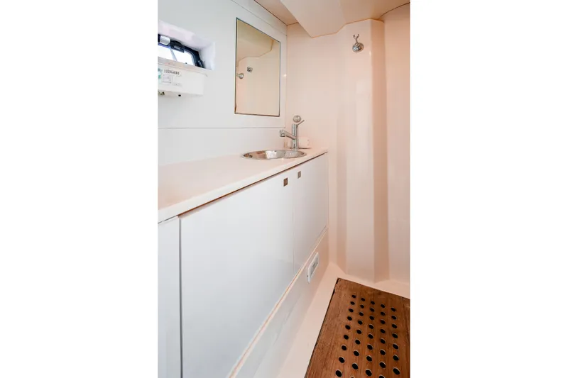 Viakarey Yacht Photos Pics Modern bathroom interior of 2023 Sirena 58 yacht, featuring sleek design and wooden flooring.