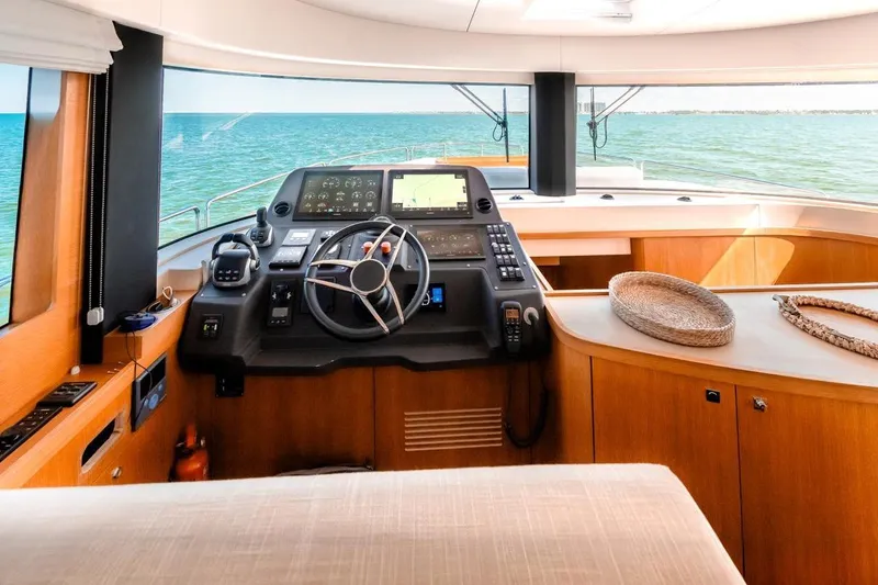 Viakarey Yacht Photos Pics Luxurious 2023 Sirena 58 yacht interior with modern helm and panoramic ocean view.