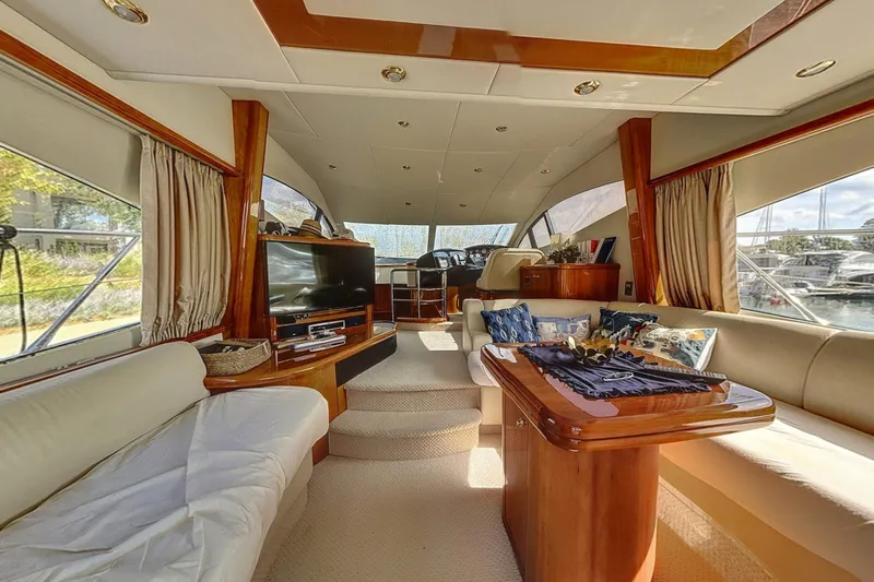  Yacht Photos Pics Luxurious interior of 2006 Sunseeker Manhattan 50 yacht with elegant furnishings and large windows.