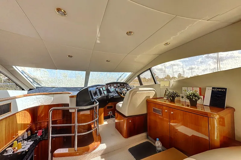  Yacht Photos Pics Luxurious interior of 2006 Sunseeker Manhattan 50 yacht with elegant helm and cabinetry.
