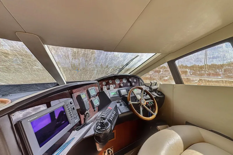  Yacht Photos Pics Interior helm of 2006 Sunseeker Manhattan 50 yacht with navigation equipment and steering wheel.