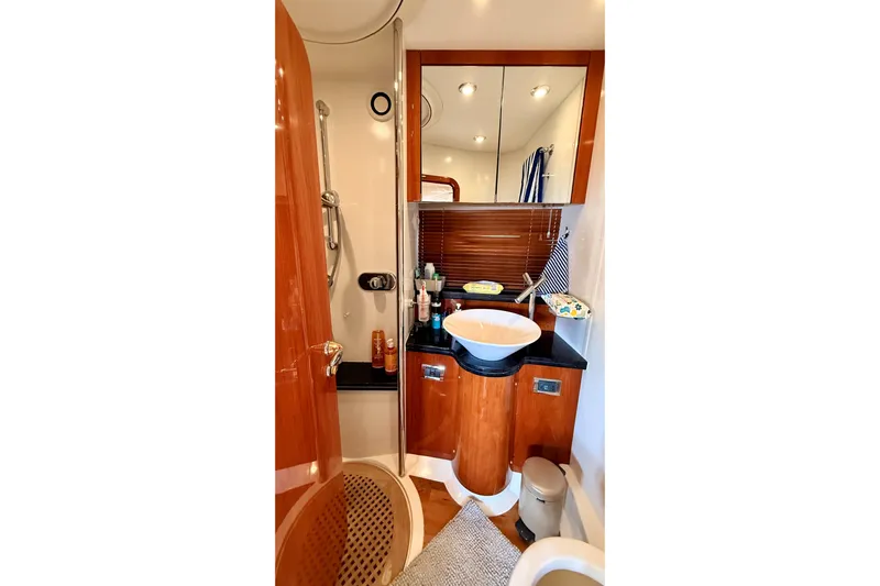  Yacht Photos Pics Luxurious bathroom in 2006 Sunseeker Manhattan 50 yacht with modern fixtures and wood accents.