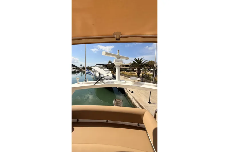  Yacht Photos Pics 2006 Sunseeker Manhattan 50 yacht docked in a sunny marina with palm trees.