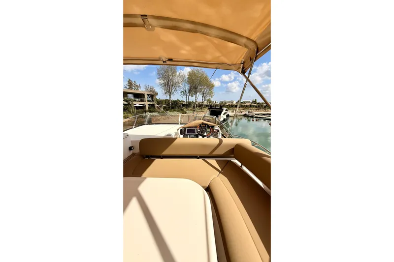  Yacht Photos Pics 2006 Sunseeker Manhattan 50 yacht interior with tan seating and marina view.