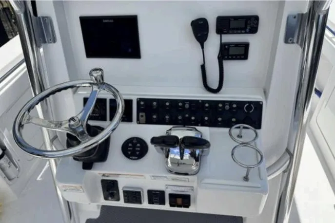  Yacht Photos Pics 2016 Southport 272 TE boat helm with steering wheel, controls, and navigation equipment.