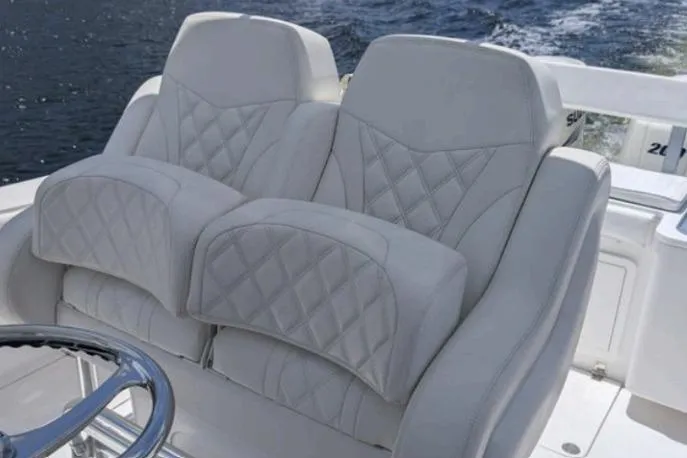  Yacht Photos Pics Luxurious seating on 2016 Southport 272 TE boat with quilted design and ocean backdrop.