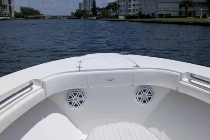  Yacht Photos Pics 2016 Southport 272 TE boat on a scenic waterway with modern buildings.