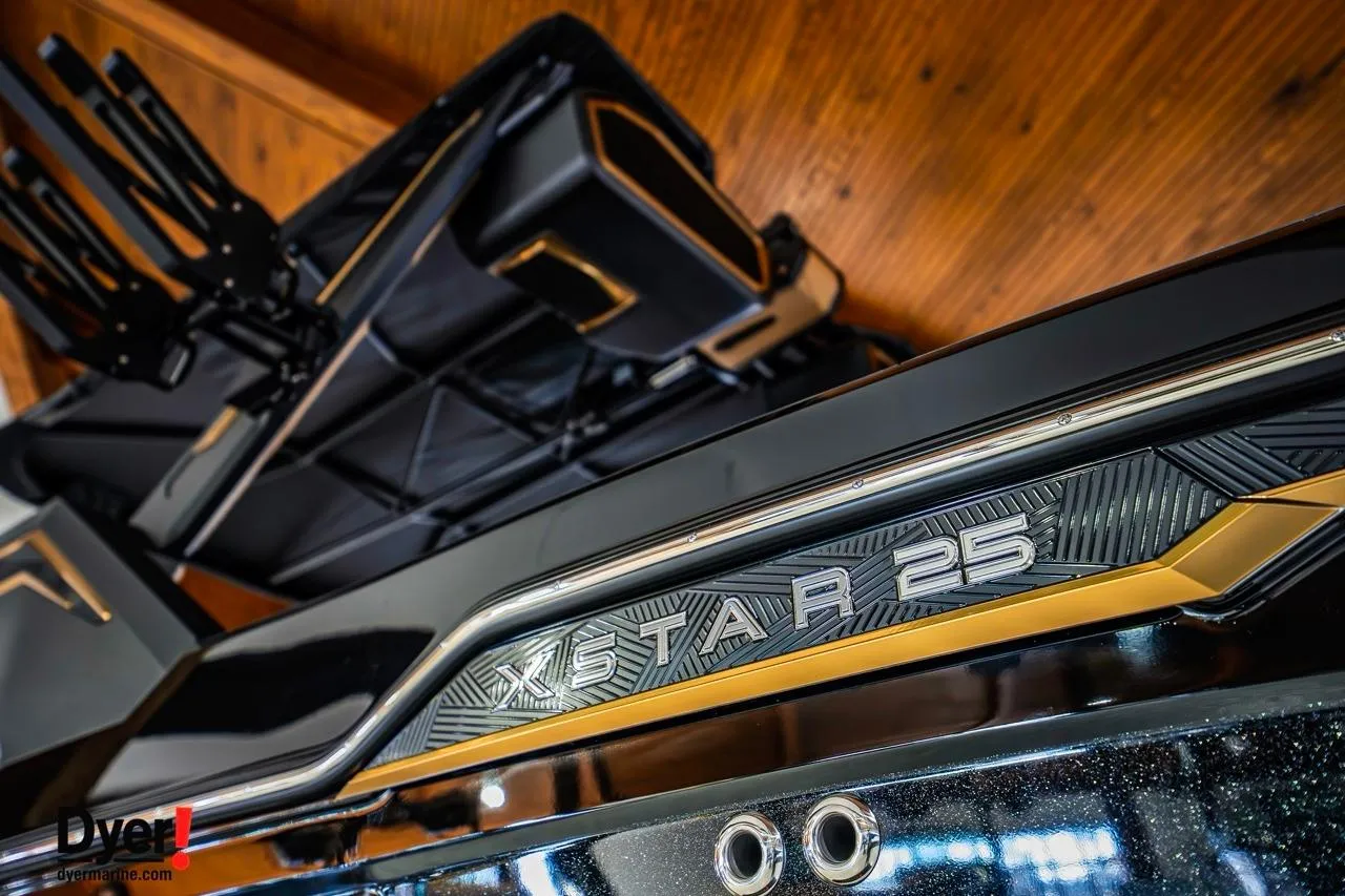 2026 MasterCraft XStar 25 boat, sleek design with metallic accents, close-up view.