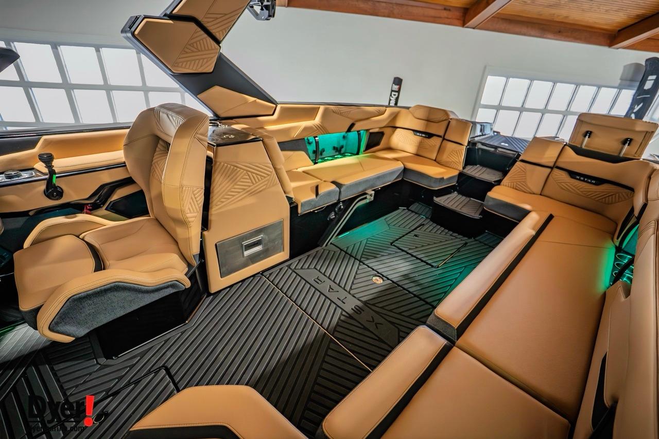Luxurious interior of 2026 MasterCraft XStar 25 boat with tan leather seating.