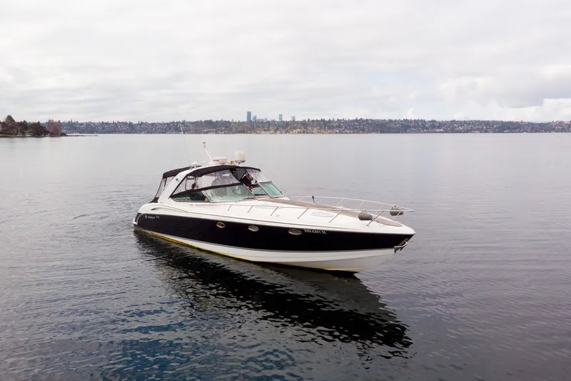  Yacht Photos Pics 2005 Formula 400 Super Sport boat on calm water with city skyline in background.