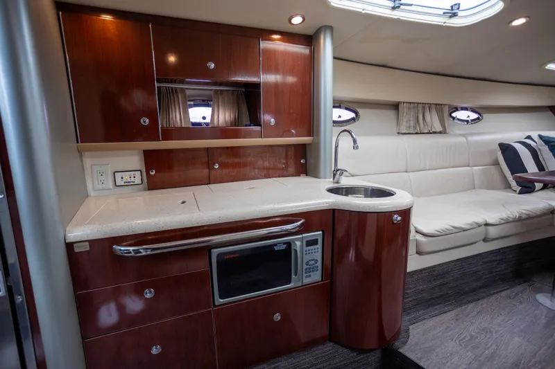  Yacht Photos Pics Luxurious interior of 2005 Formula 400 Super Sport yacht with kitchenette and seating area.