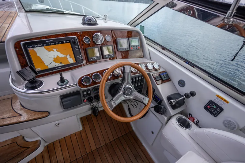  Yacht Photos Pics 2005 Formula 400 Super Sport boat cockpit with navigation system and wooden steering wheel.