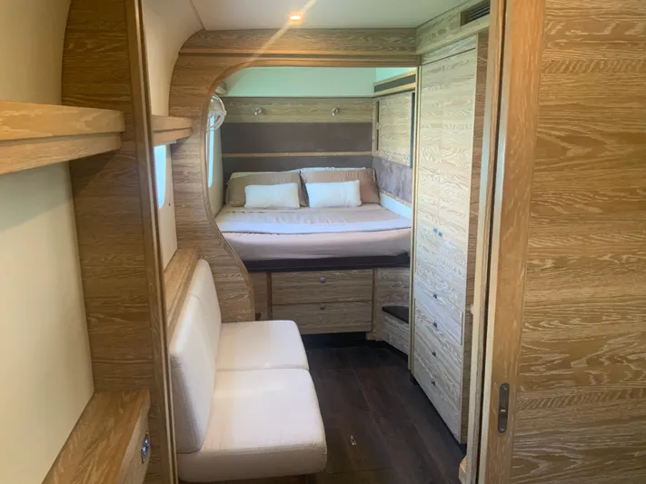 Vanquish Yacht Photos Pics Luxurious interior of 2018 Xquisite Yachts X5, featuring a cozy bedroom and elegant wood finishes.