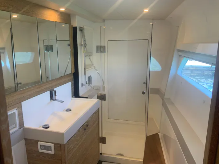 Vanquish Yacht Photos Pics Luxurious bathroom in 2018 Xquisite Yachts X5, featuring modern fixtures and ample natural light.