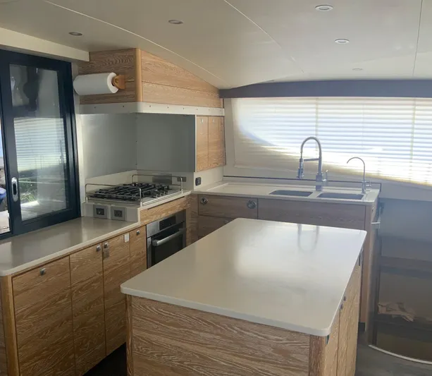 Vanquish Yacht Photos Pics Luxurious kitchen interior of 2018 Xquisite Yachts X5 with modern appliances and wood finish.