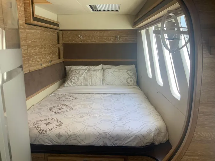 Vanquish Yacht Photos Pics Luxurious bedroom interior of 2018 Xquisite Yachts X5 with elegant bedding and wood accents.