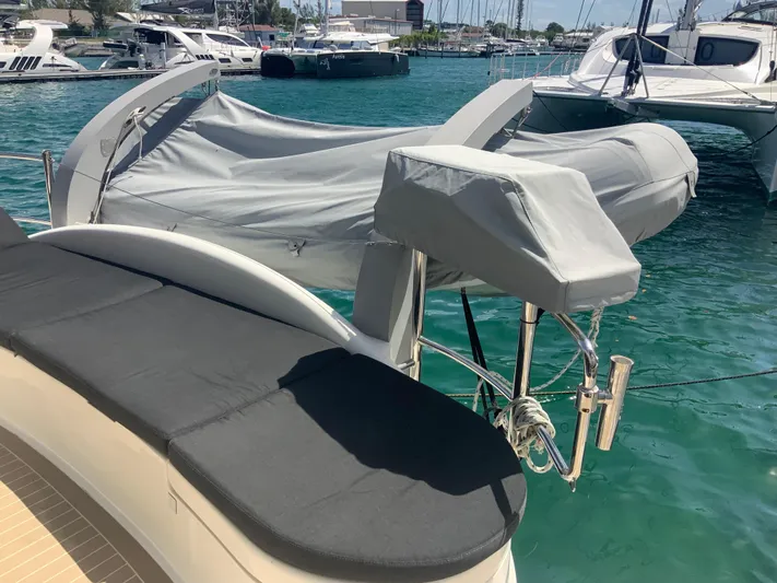 Vanquish Yacht Photos Pics 2018 Xquisite Yachts X5 with covered dinghy on turquoise water.