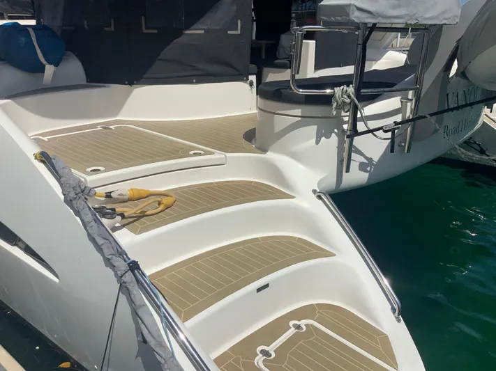 Vanquish Yacht Photos Pics 2018 Xquisite Yachts X5 deck with teak flooring and stainless steel railings.