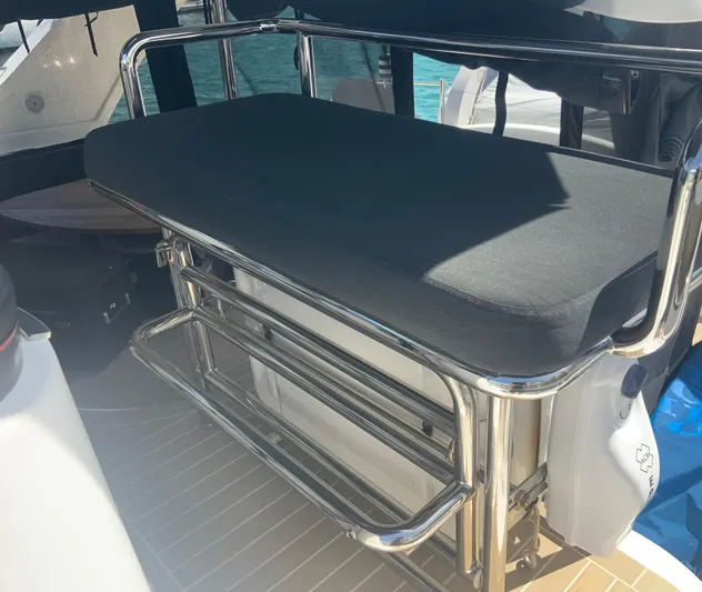 Vanquish Yacht Photos Pics 2018 Xquisite Yachts X5 seating area with stainless steel frame and cushioned bench.