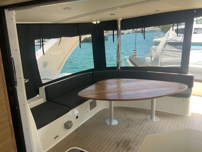 Vanquish Yacht Photos Pics Luxurious 2018 Xquisite Yachts X5 interior with elegant seating and wooden table.