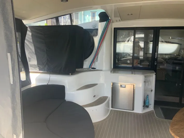 Vanquish Yacht Photos Pics 2018 Xquisite Yachts X5 interior with seating, steps, and kitchenette area.