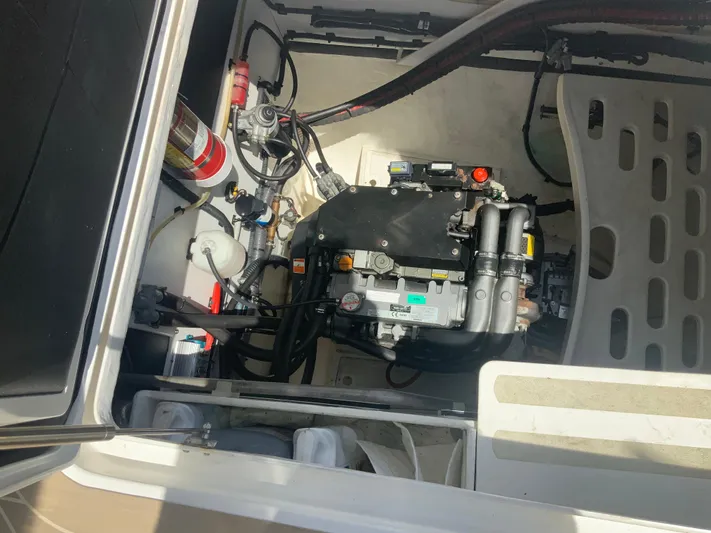 Vanquish Yacht Photos Pics Engine compartment of 2018 Xquisite Yachts X5, showcasing mechanical components and fire extinguisher.