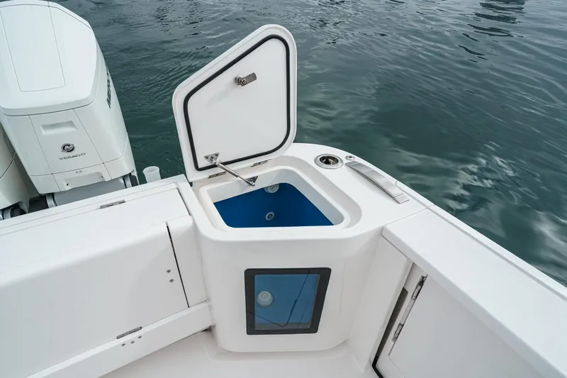 R&r 5 Yacht Photos Pics 2022 Intrepid 477 Evolution boat with open storage compartment and Mercury Verado engine.