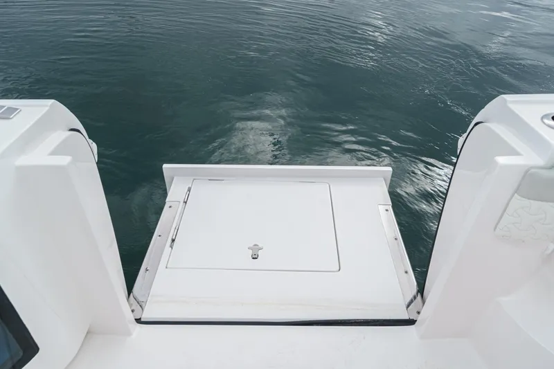 R&r 5 Yacht Photos Pics 2022 Intrepid 477 Evolution boat swim platform on calm water.