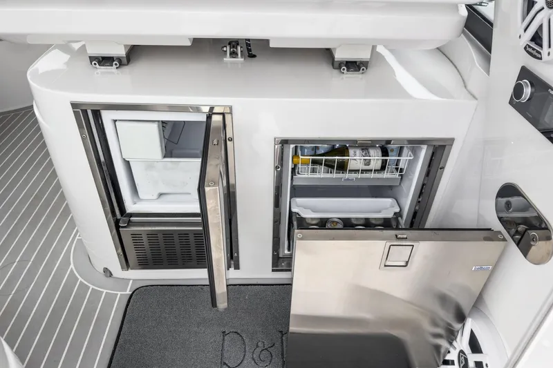 R&r 5 Yacht Photos Pics 2022 Intrepid 477 Evolution yacht with open stainless steel refrigerator and storage compartments.