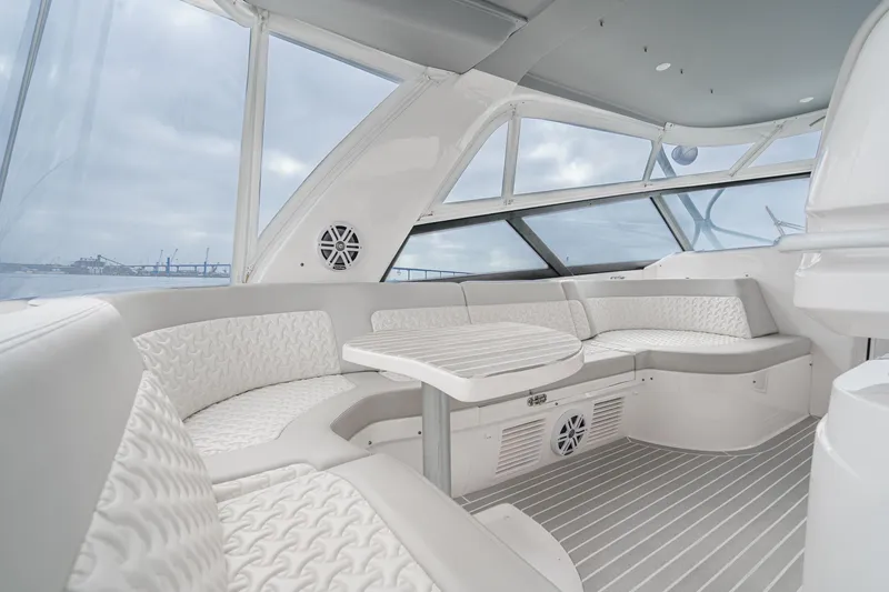 R&r 5 Yacht Photos Pics Luxurious interior of 2022 Intrepid 477 Evolution yacht with elegant seating and panoramic windows.