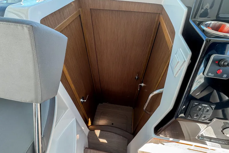  Yacht Photos Pics 2025 Beneteau Antares 9 interior cabin entrance with wooden door and modern controls.