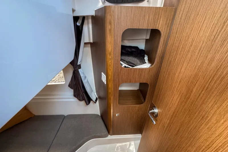  Yacht Photos Pics Interior of 2025 Beneteau Antares 9, featuring wooden cabinetry and seating area.