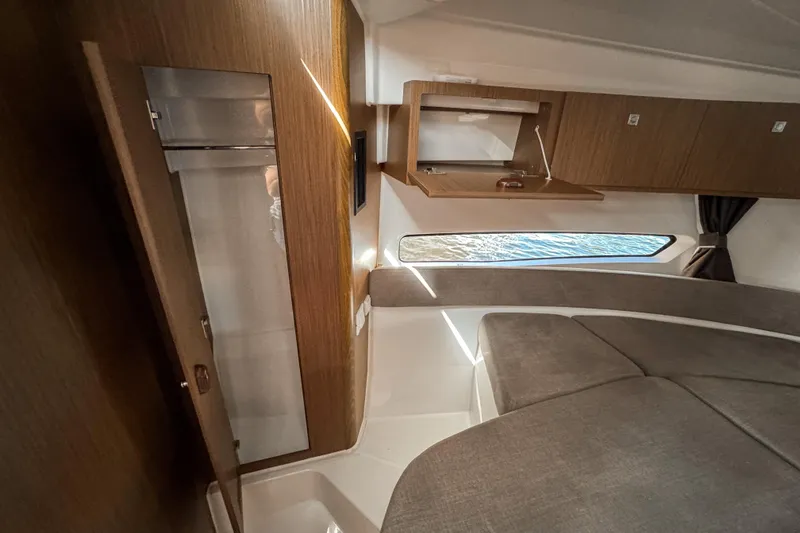  Yacht Photos Pics 2025 Beneteau Antares 9 cabin interior with wood finish and modern design.