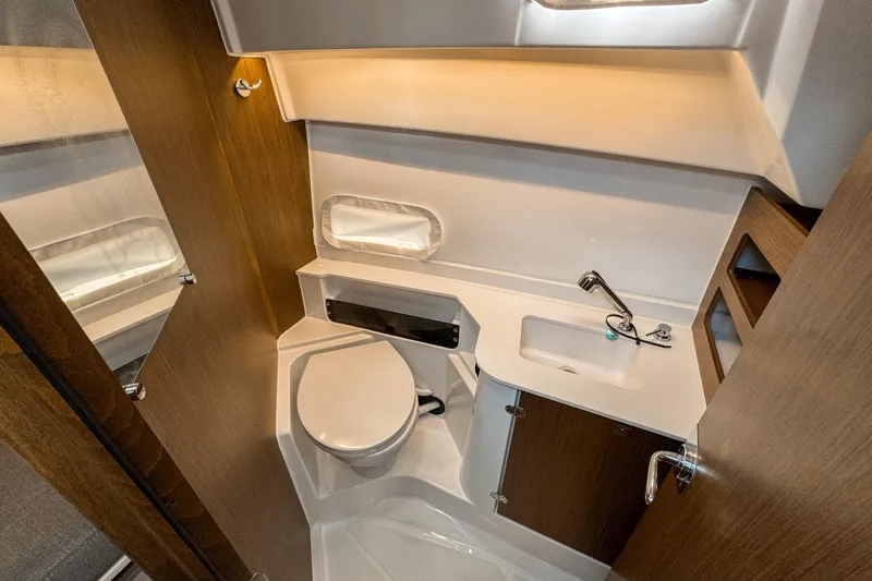  Yacht Photos Pics 2025 Beneteau Antares 9 bathroom interior with modern fixtures and wood accents.