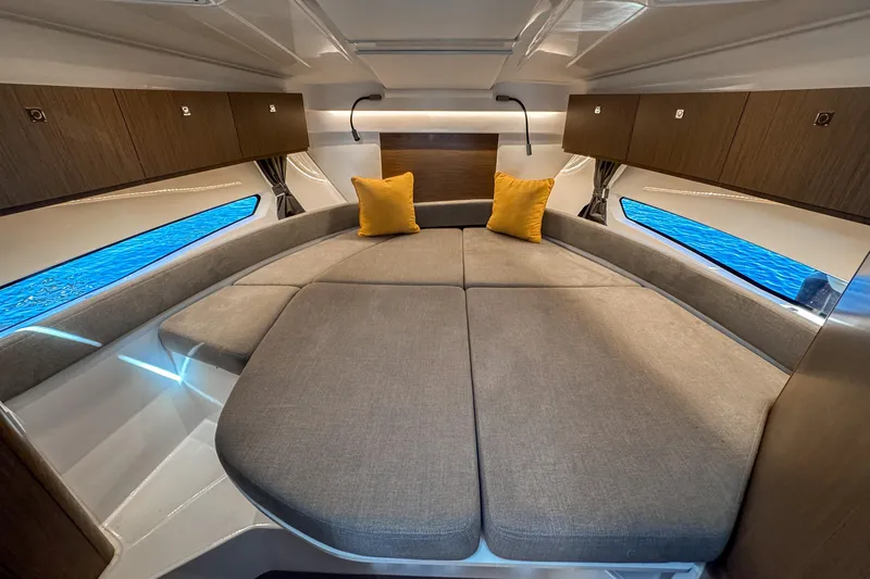  Yacht Photos Pics Luxurious interior of 2025 Beneteau Antares 9 with cozy bedding and modern design.