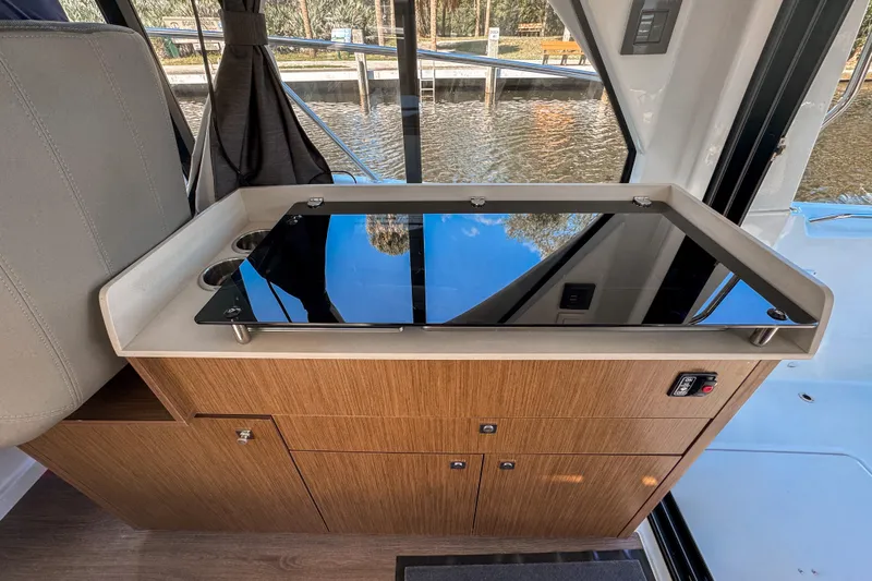  Yacht Photos Pics 2025 Beneteau Antares 9 interior with sleek wooden cabinetry and modern design.