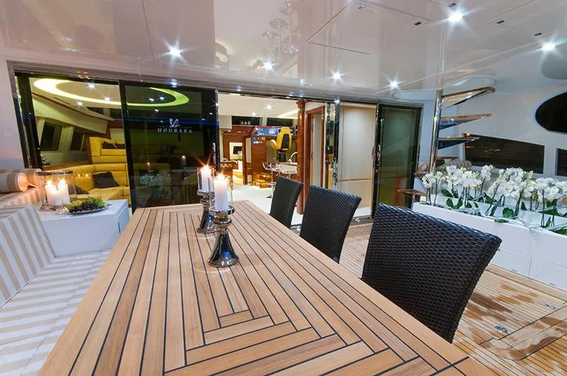 Houbara Yacht Photos Pics Luxurious Sunreef 82 DD yacht interior with elegant dining area, candles, and modern decor, 2012 model.