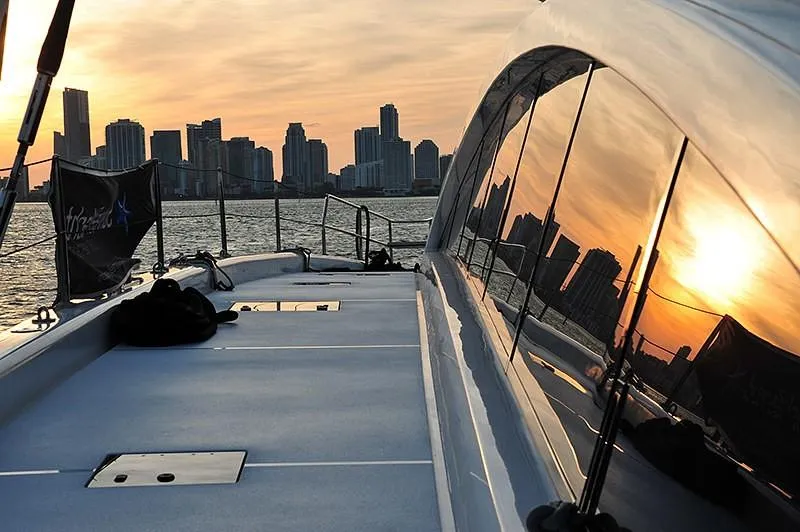 Houbara Yacht Photos Pics Sunreef 82 DD yacht deck with city skyline and sunset reflection, 2012 model.