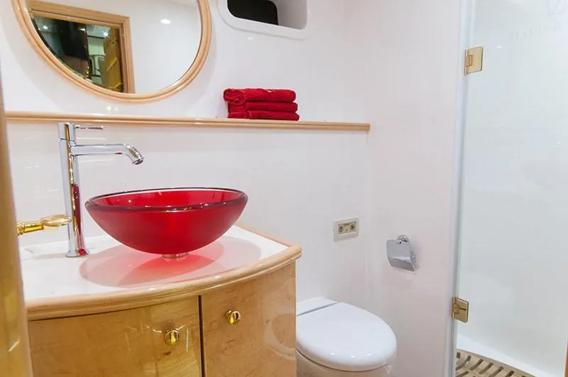 Houbara Yacht Photos Pics Luxurious bathroom on 2012 Sunreef 82 DD yacht with red glass sink and modern fixtures.