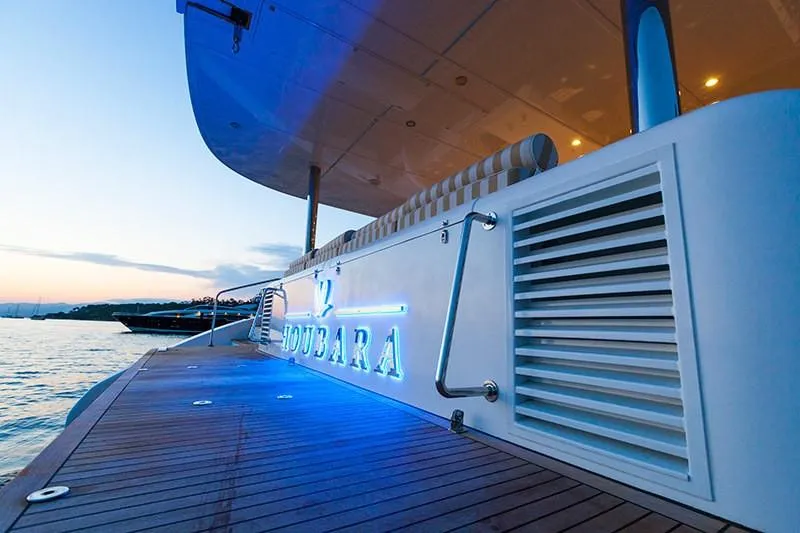 Houbara Yacht Photos Pics Luxurious Sunreef 82 DD yacht, 2012 model, with elegant deck and ambient lighting at sunset.