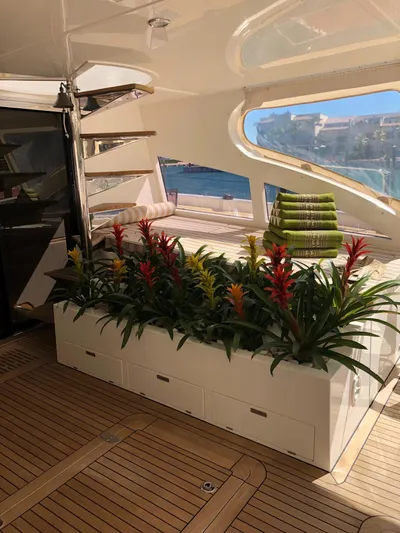 Houbara Yacht Photos Pics Luxurious Sunreef 82 DD yacht interior with vibrant flowers and elegant wooden flooring, 2012 model.