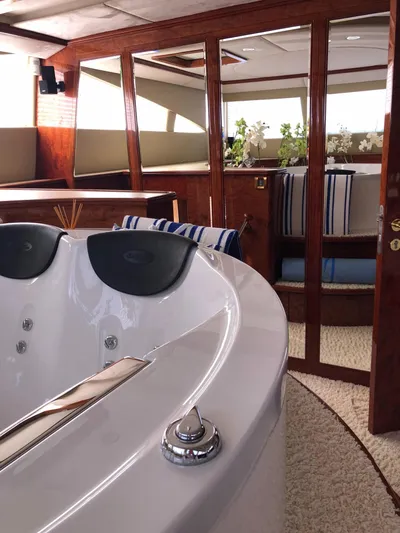Houbara Yacht Photos Pics Luxurious interior of 2012 Sunreef 82 DD yacht featuring a jacuzzi and elegant wood finishes.