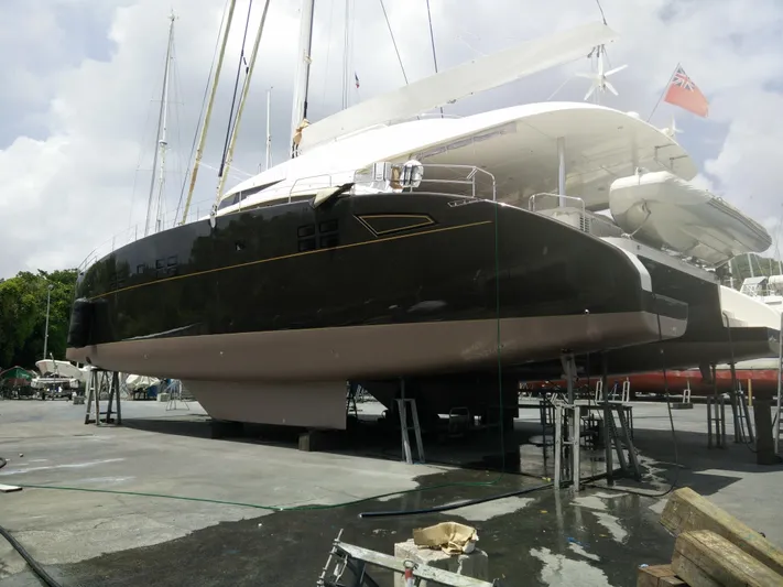 Houbara Yacht Photos Pics Luxury Sunreef 82 DD yacht from 2012 on dry dock, showcasing sleek design and craftsmanship.