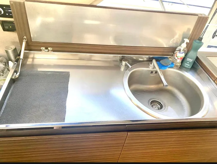 Concepcion 1641 Yacht Photos Pics Kitchen sink area in a 2013 Azimut 55S yacht, featuring stainless steel fixtures.
