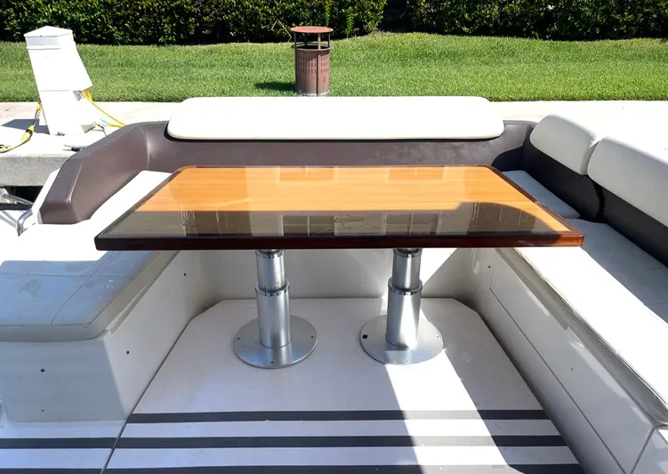 Concepcion 1641 Yacht Photos Pics 2013 Azimut 55S yacht seating area with wooden table and cushioned benches.