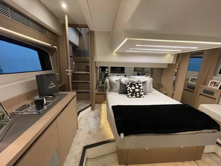  Yacht Photos Pics Luxurious interior of a 2018 Prestige 520S yacht bedroom with modern decor and ambient lighting.