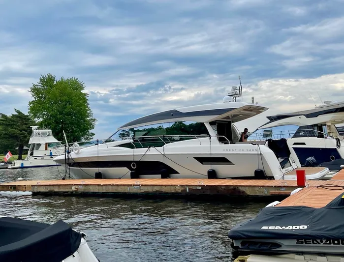  Yacht Photos Pics 2018 Prestige 520S yacht docked at marina under cloudy sky.