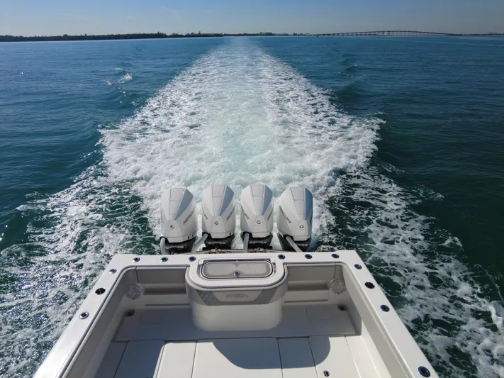  Yacht Photos Pics 2022 Invincible 42 Open Fisherman boat with four engines cruising on open water.